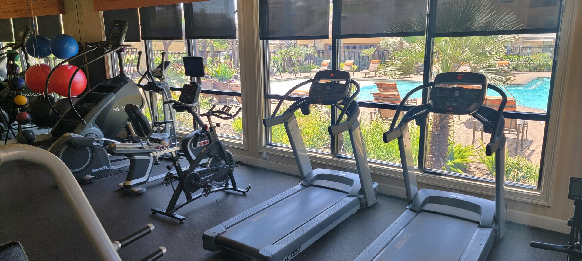 Hotel fitness center with pool view — gym equipment serviced by Fitness Repair Xperts Houston TX